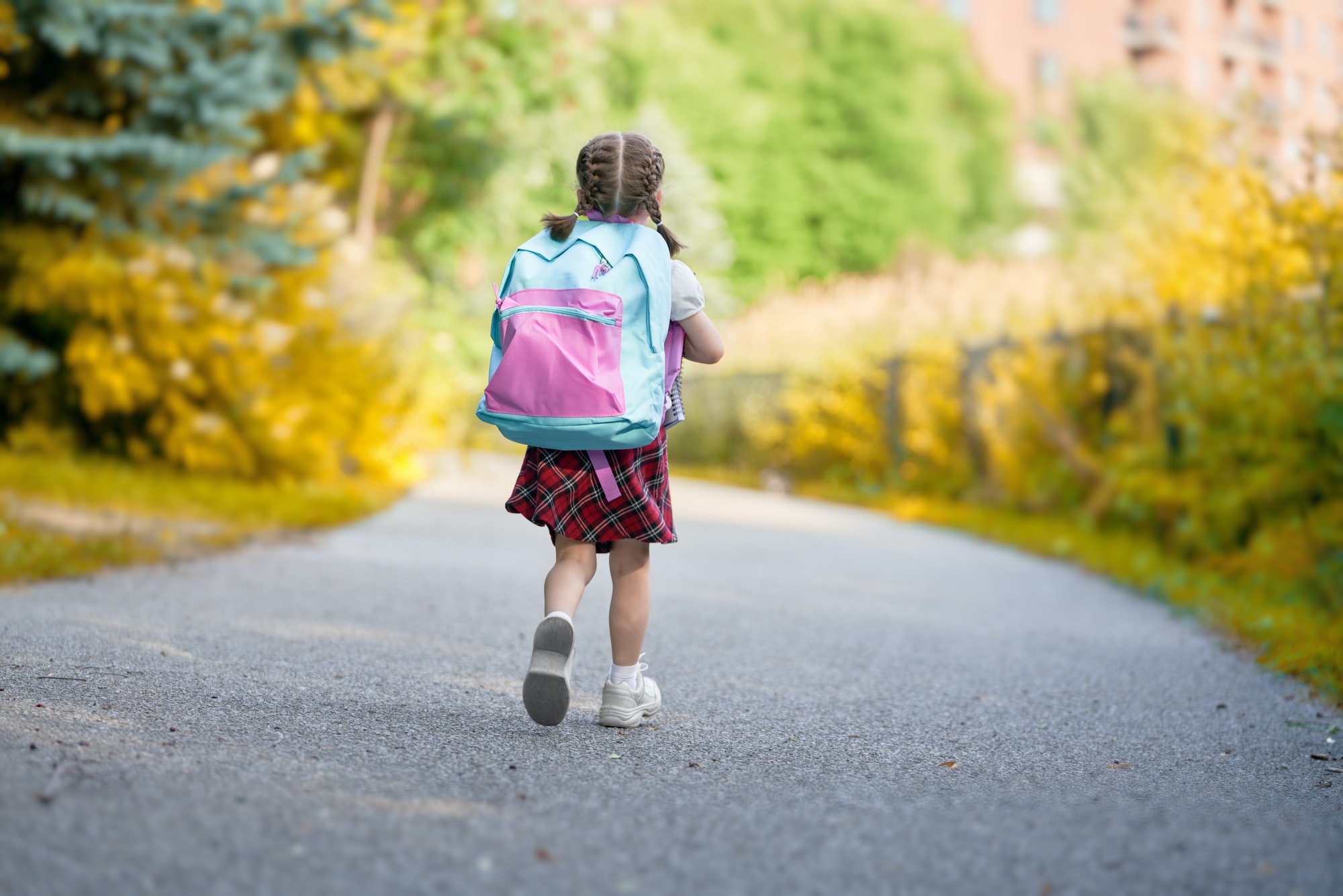 Girl with backpack is going to school