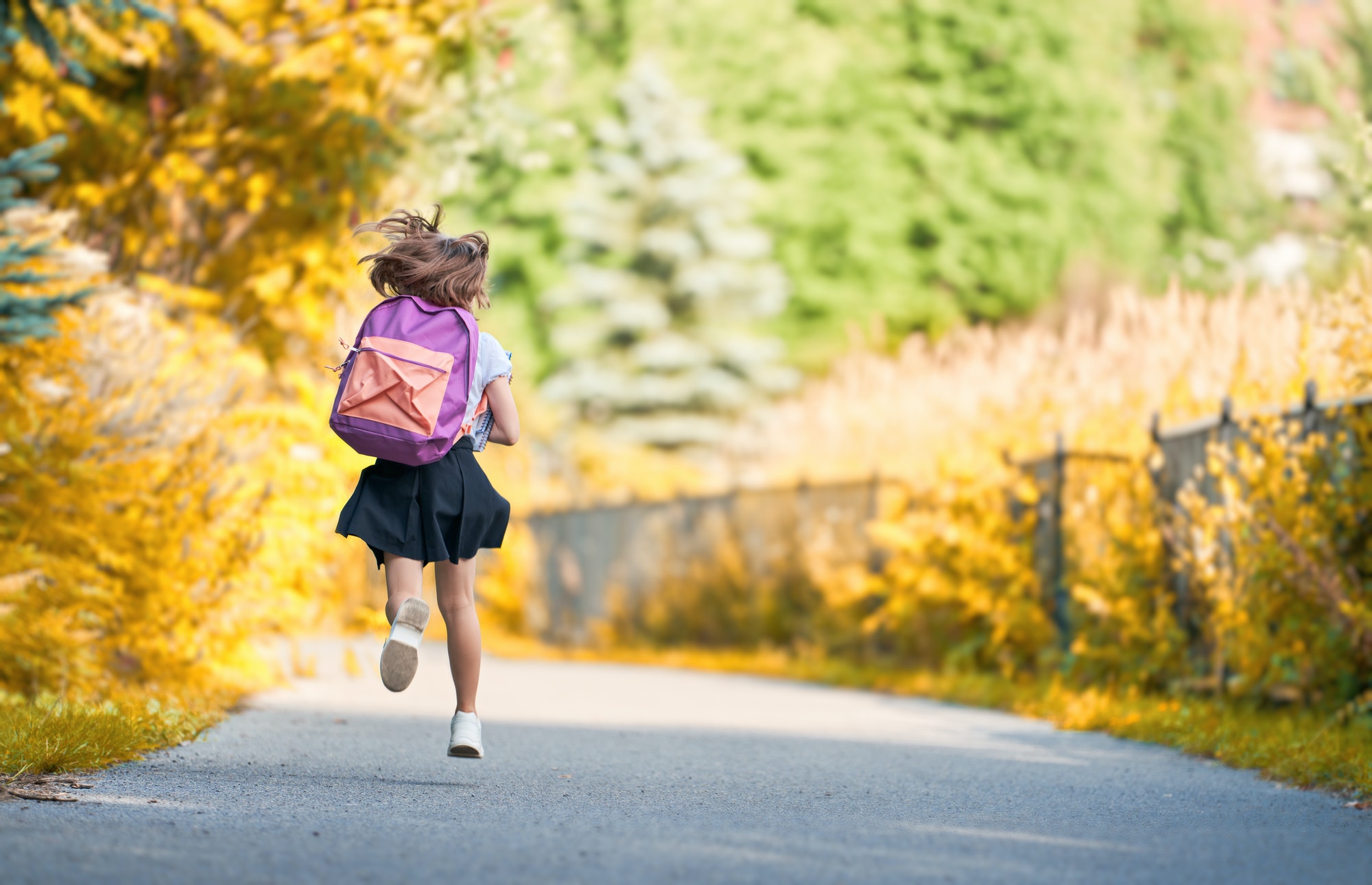 Girl with backpack is going to school