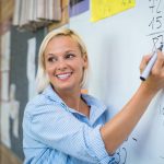 Teacher teaching math on whiteboard