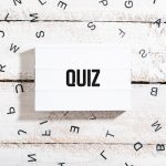 Quiz text on light box with chaos letters on white wood table desk