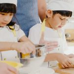 Young Asian Japanese family with preschool kids have cooking for breakfast in modern kitchen home.