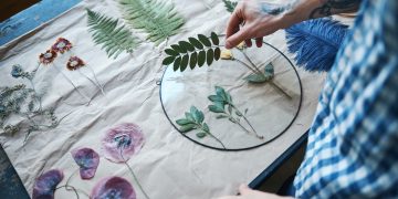 Young man herbalist making herbarium at home