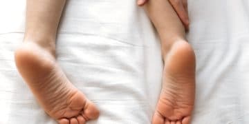 foot massage. children's feet, hands of a masseur